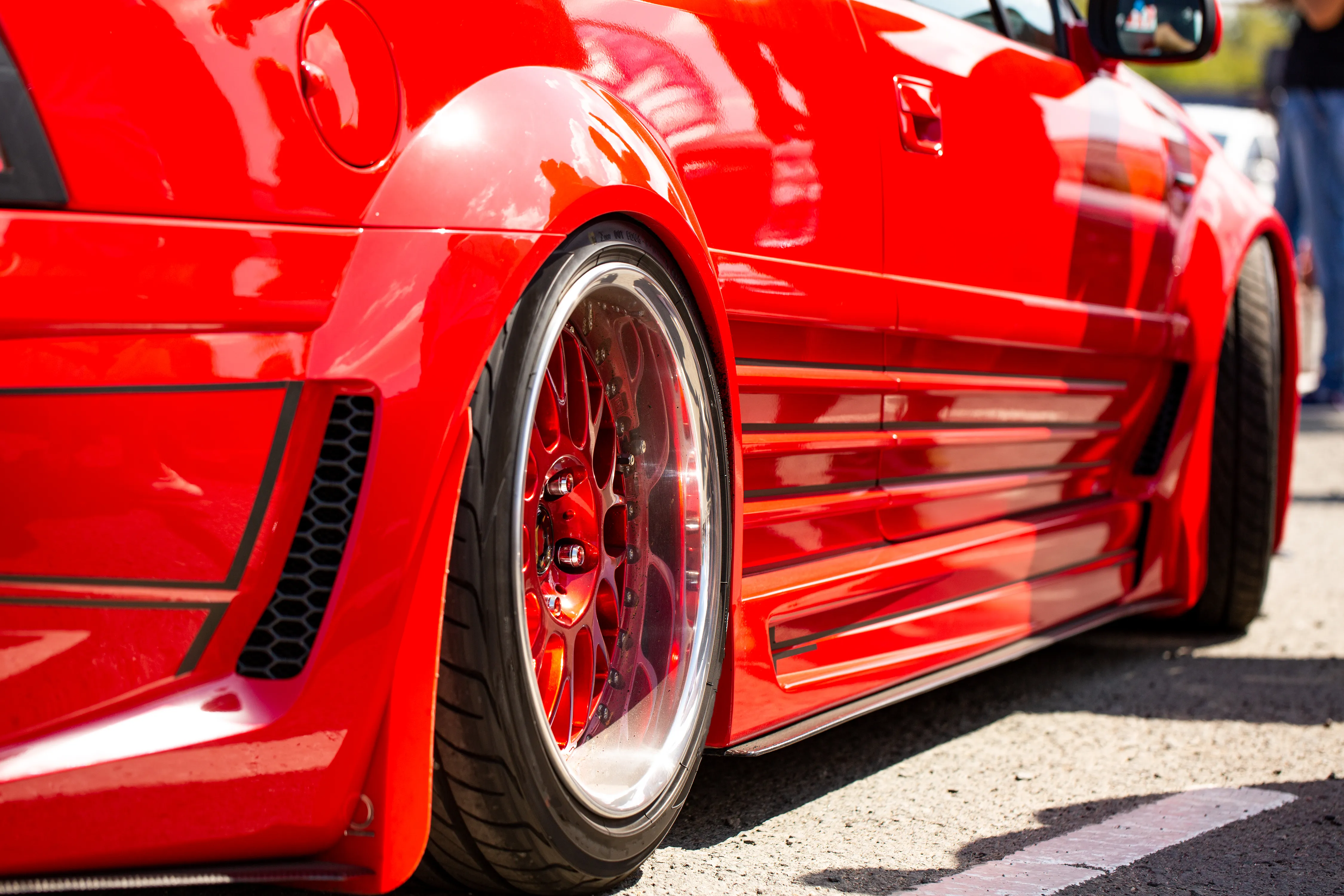 red car parked on the side of the road