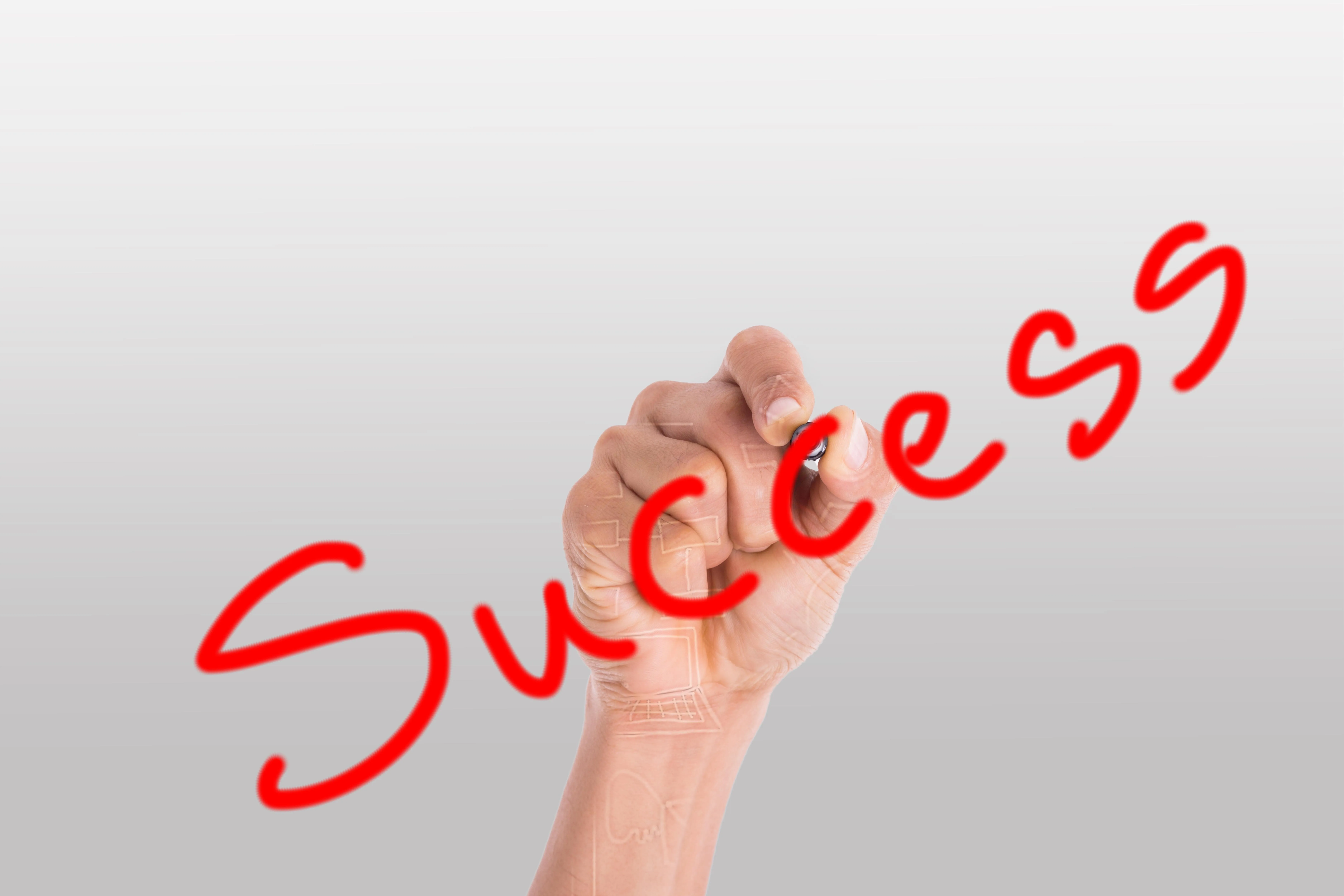 Handwriting "Success" with a marker.